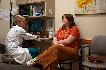 Student meeting with a provider in a Student Health exam room